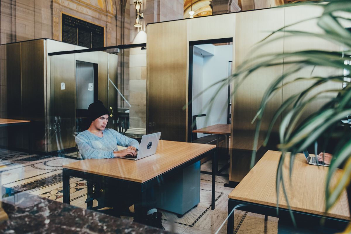 man using a gray laptop computer