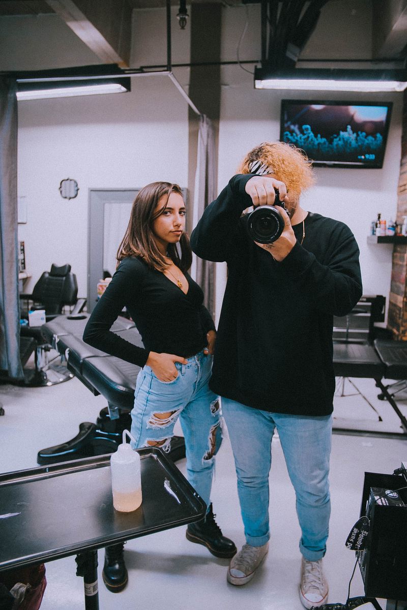 man using DSLR camera taking a mirror photo