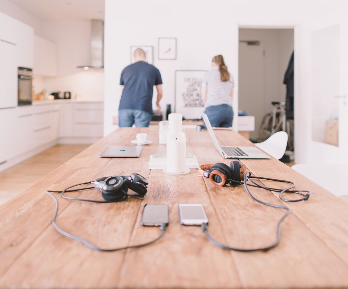 orange and black headphones on table
