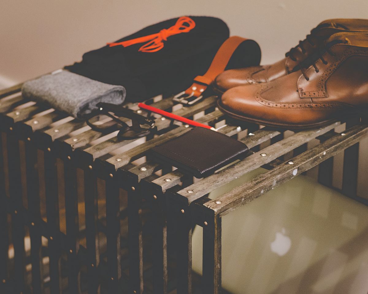 pair of brown leather dress shoes beside black leather wallet