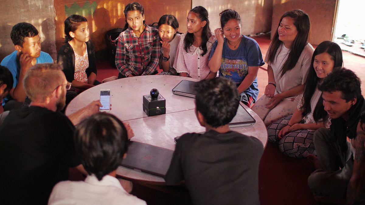 people sitting on floor front of table