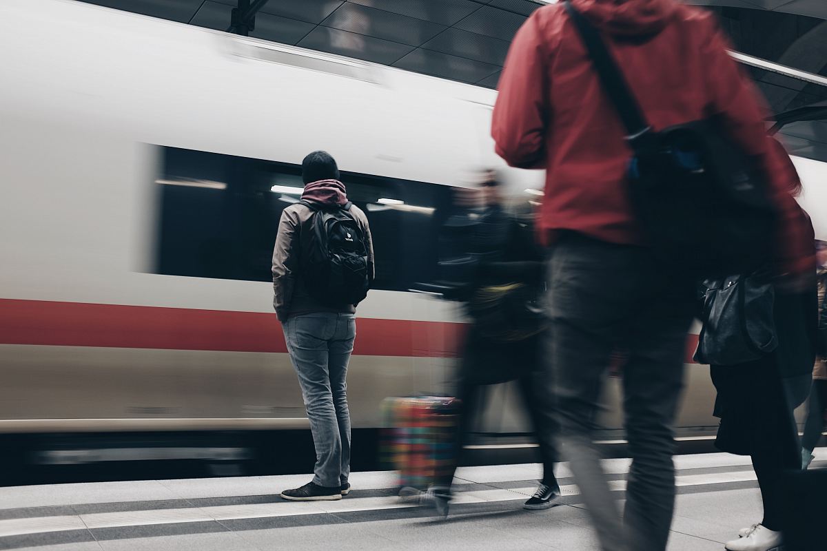 people standing beside train