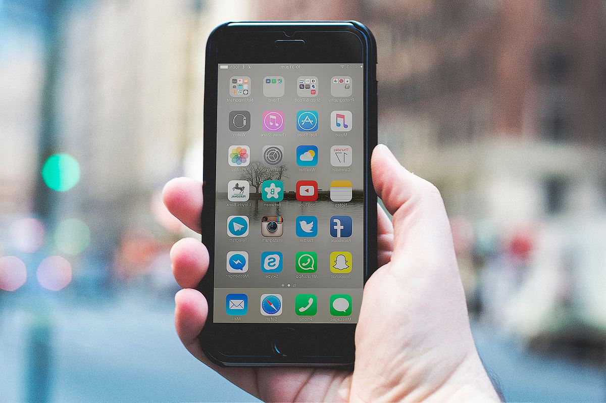 person holding a space gray iPhone 6 and black case
