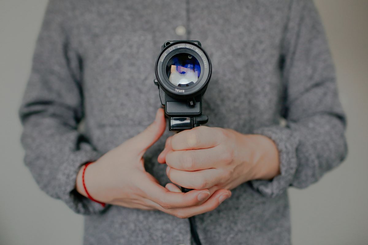 person holding DSLR camera