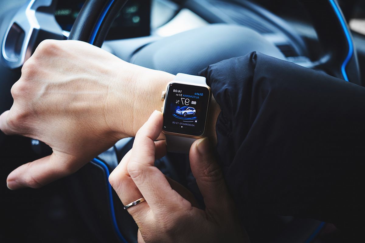 person holding gold aluminum Apple Watch