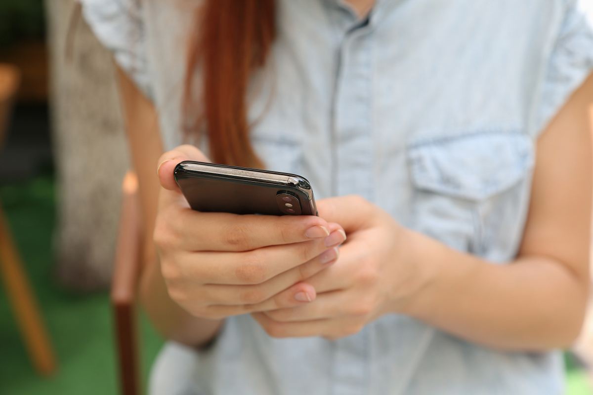 person holding using iPhone X