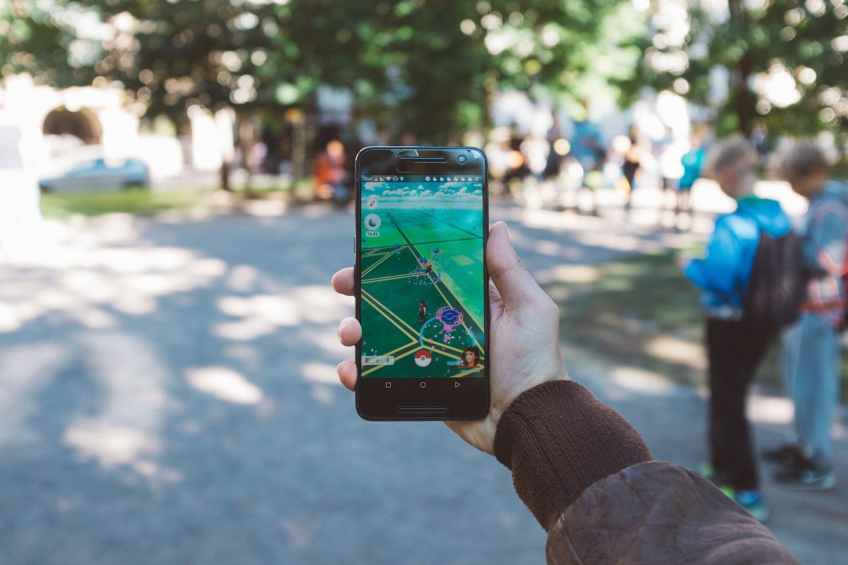 person playing Pokemon Go during daytime