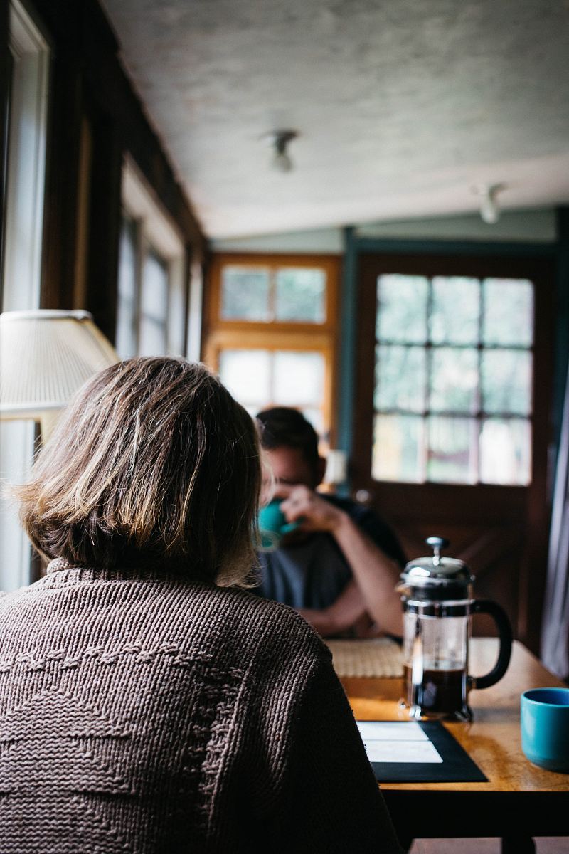 person sitting in front of table with coffee press