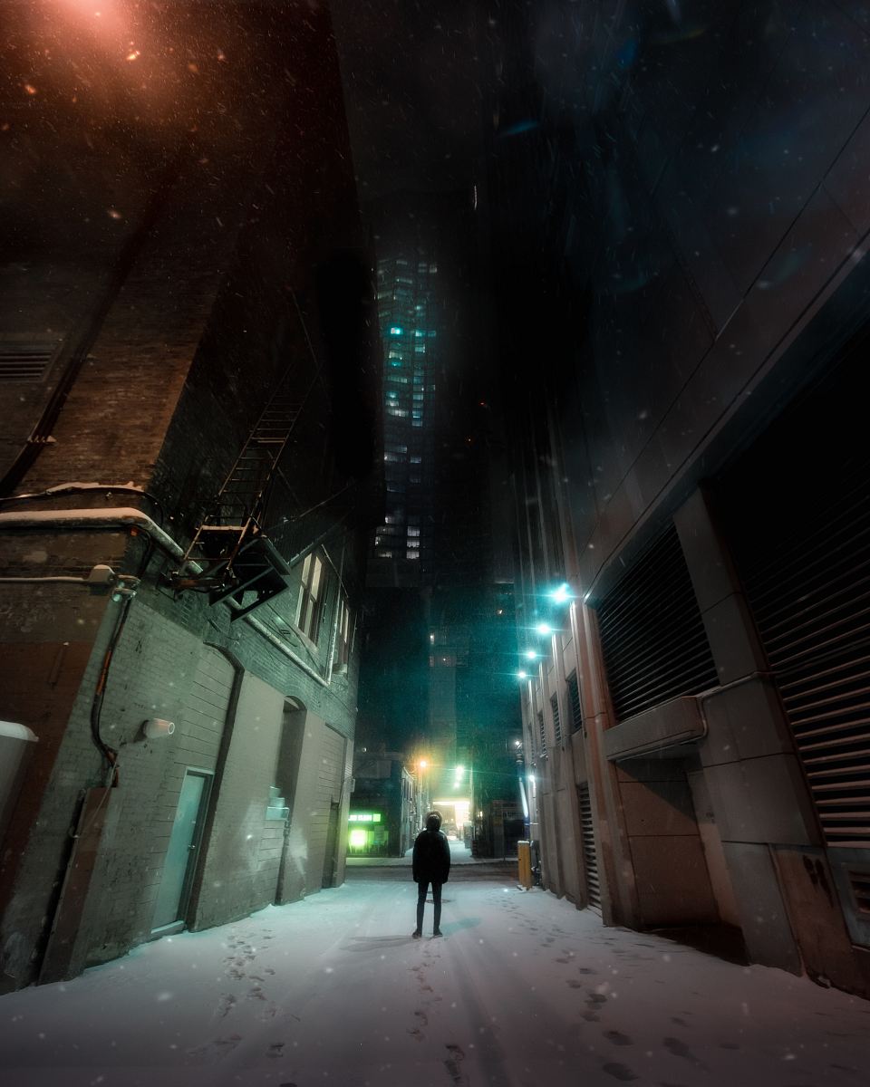 person standing between concrete buildings