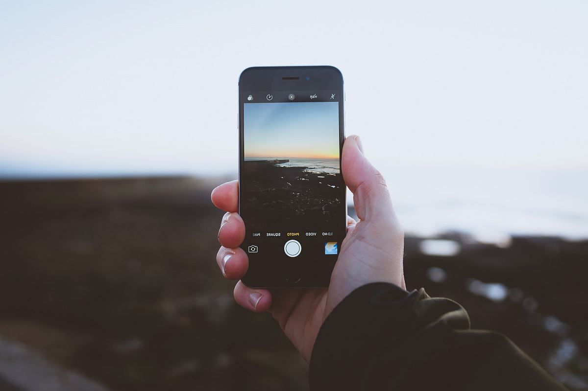 Person Taking Photo Of Landscapes Using IPhone During Daytime Image ...