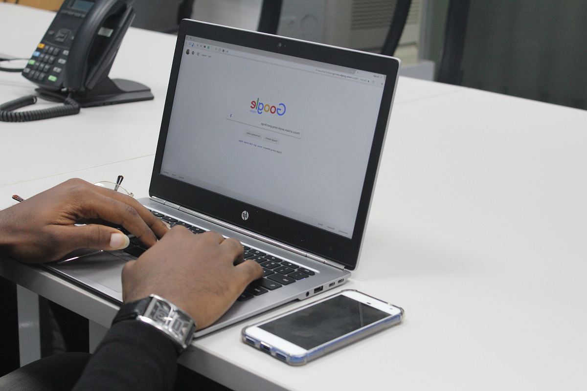 person typing on gray and black HP laptop