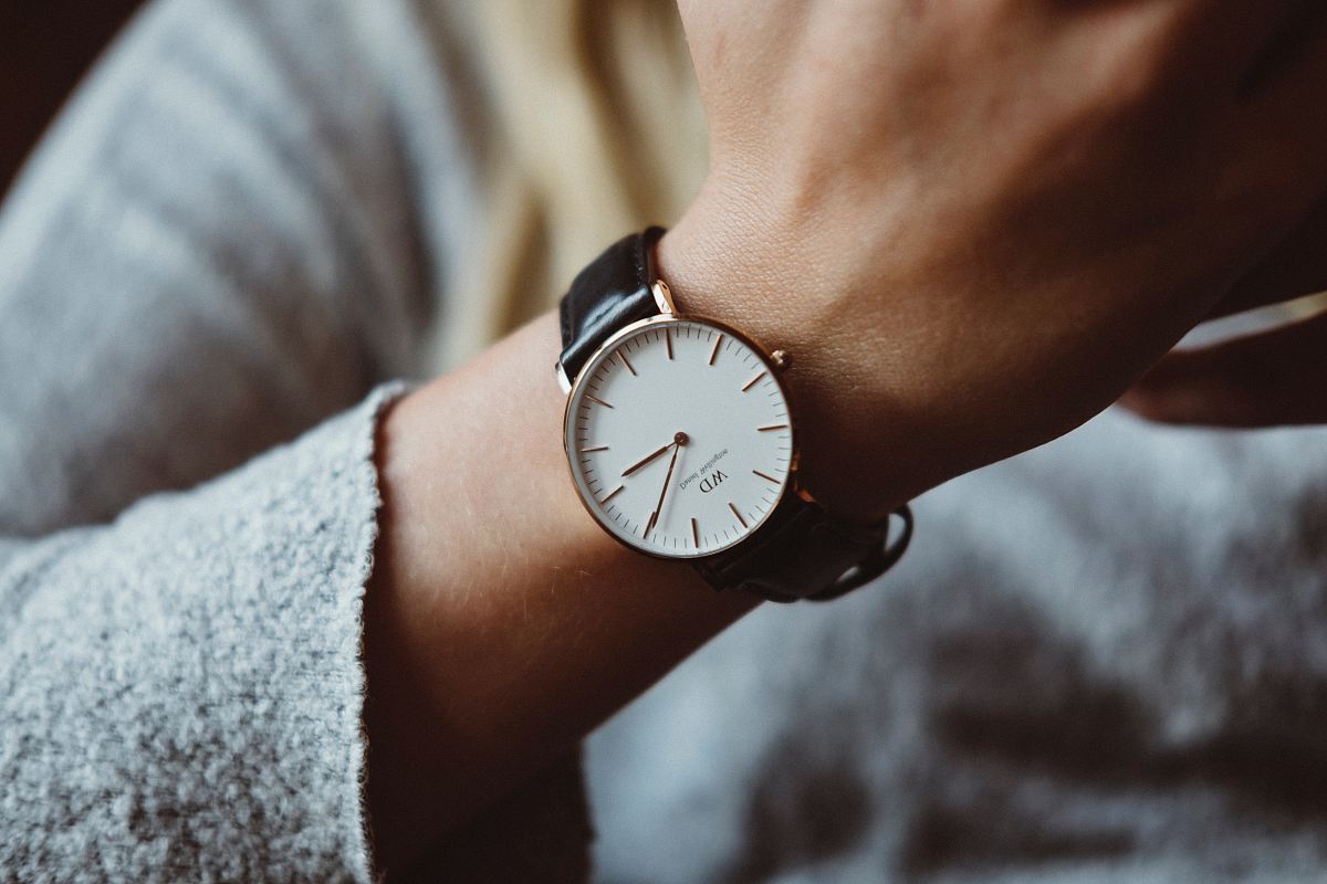 person wearing analog watch