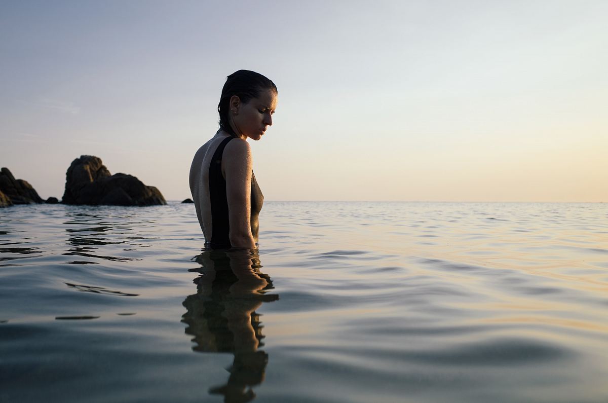 photo of woman on sea during daytime
