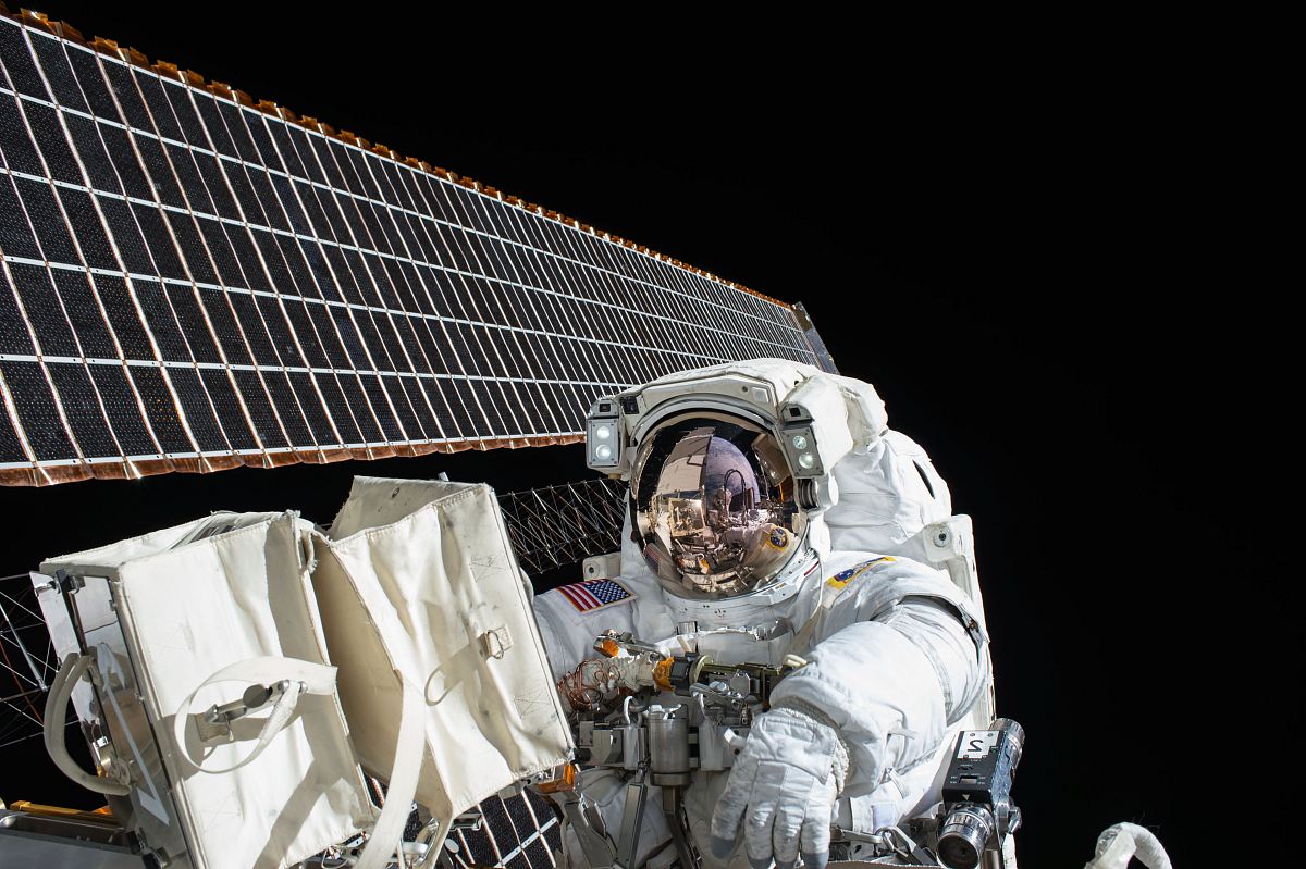 photography of Astronaut beside satellite