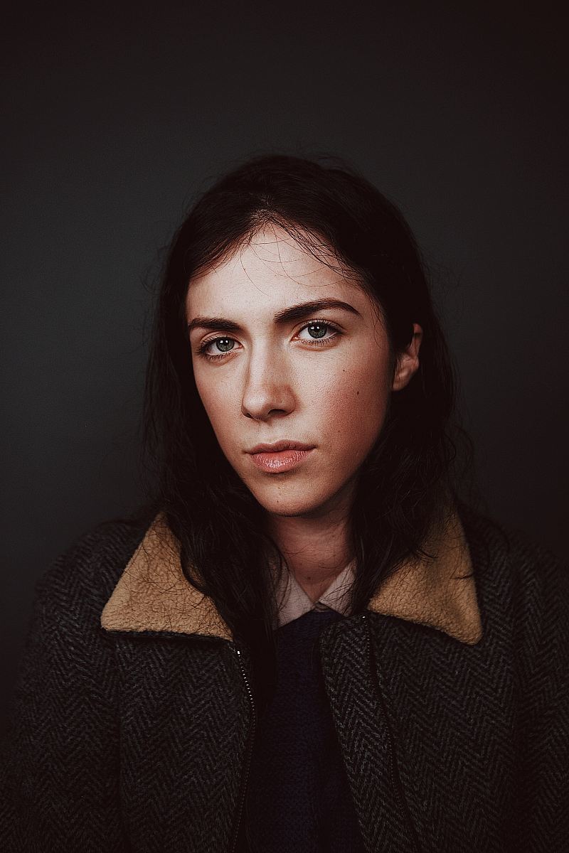 portrait photograph of woman in gray and brown coat