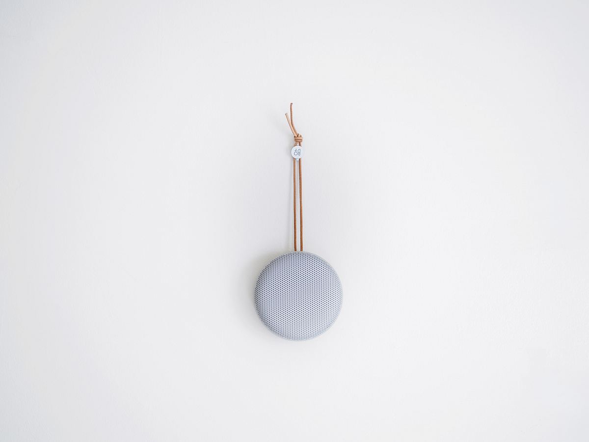 round grey hanging decor on white wall