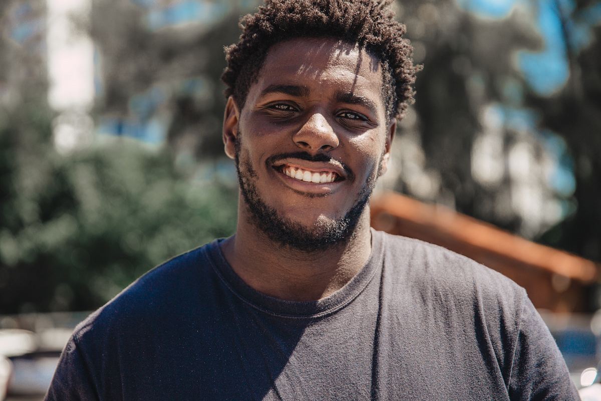 selective focus of man smiling during daytime