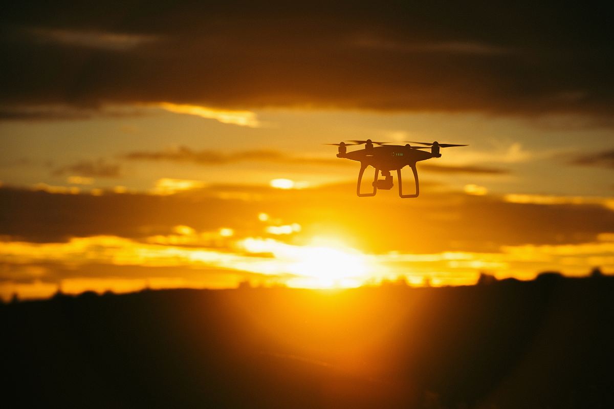 silhouette camera drone flying midair