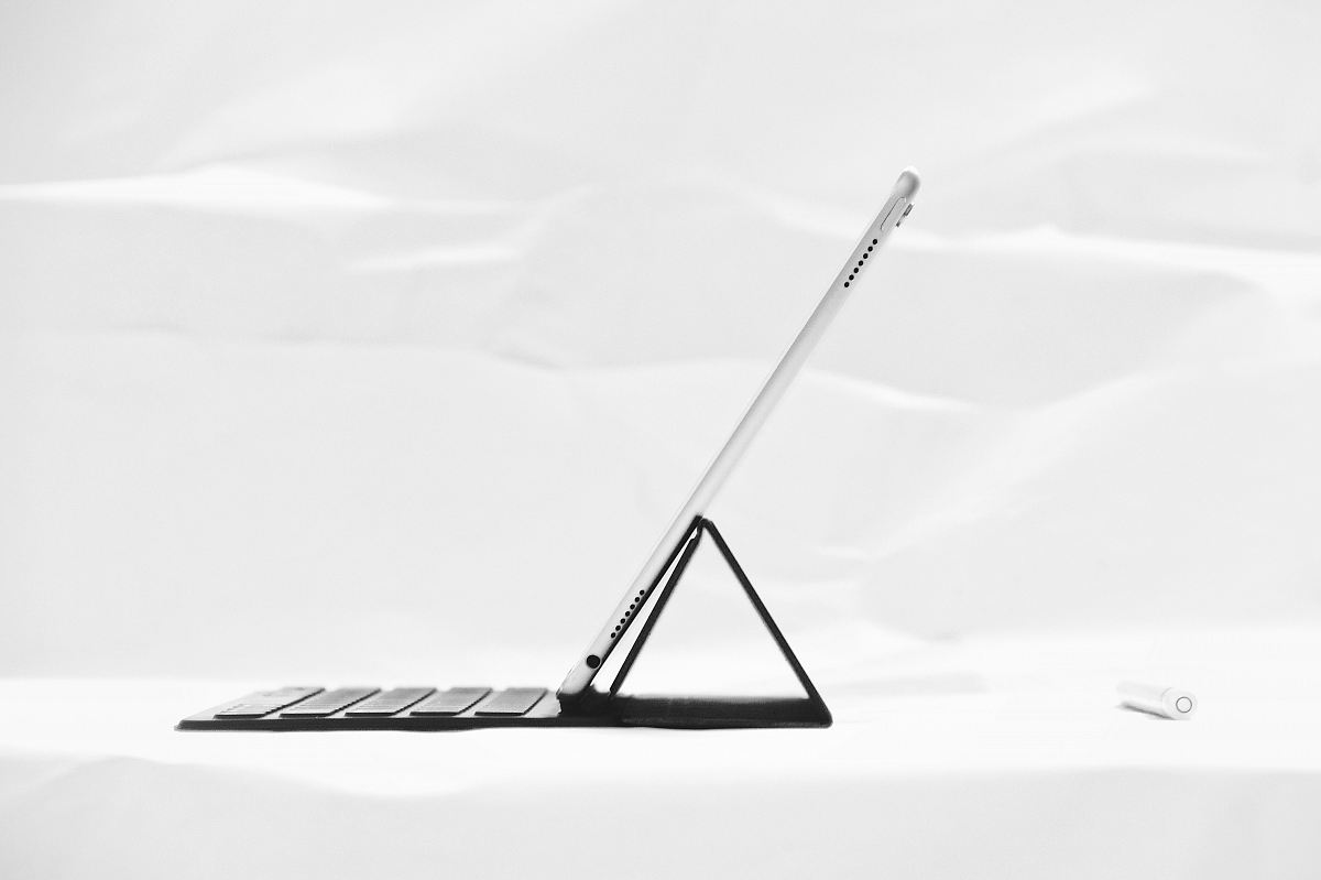 silver iPad on black dock keyboard