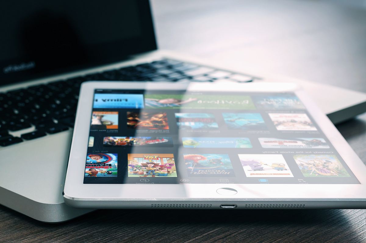 silver iPad on top of MacBook Pro