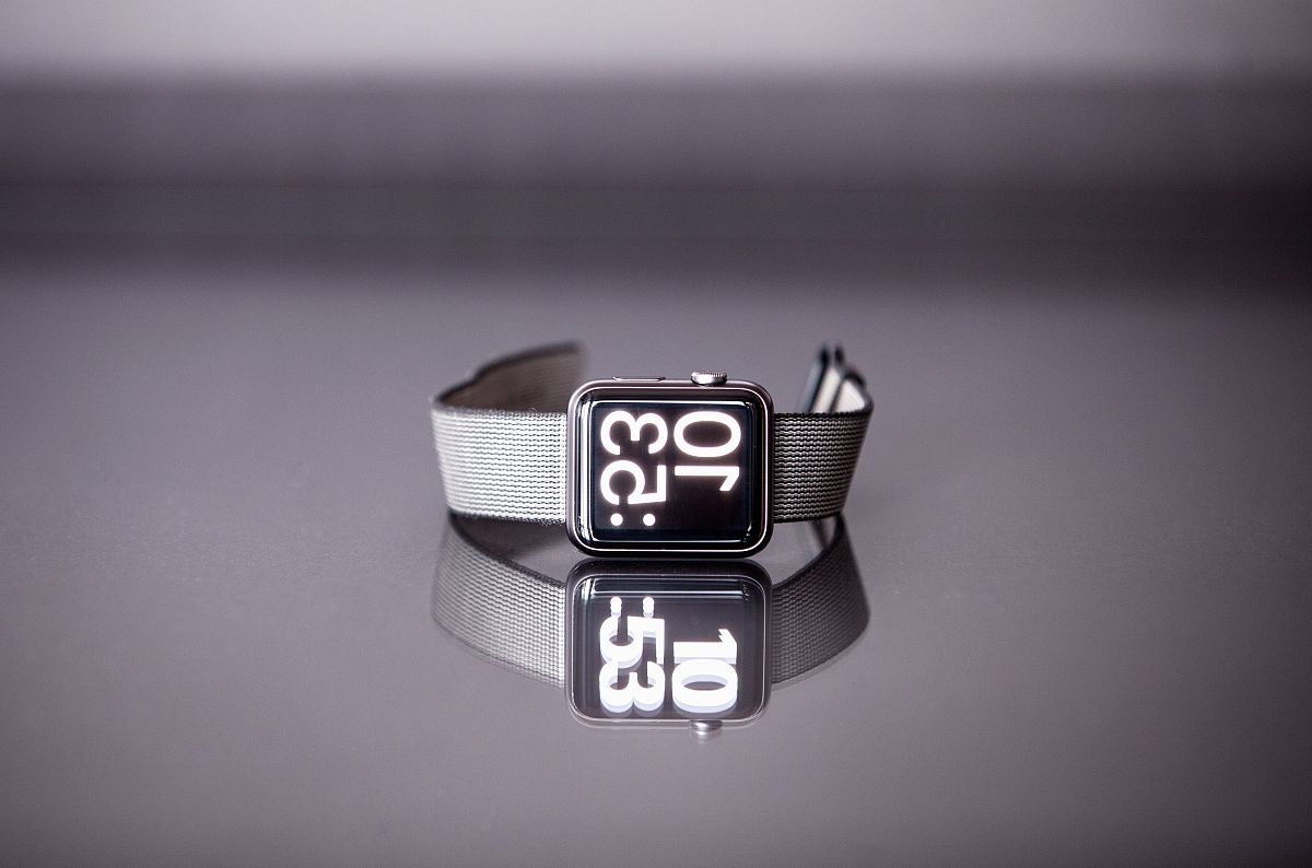 silver titanium Apple Watch with gray nylon strap