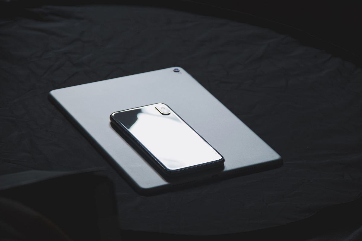 space gray iPhone X on tablet computer