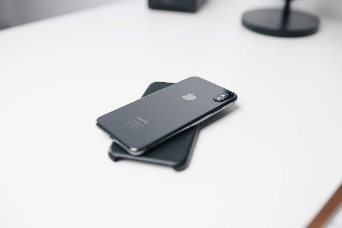 space gray iPhone X on white surface
