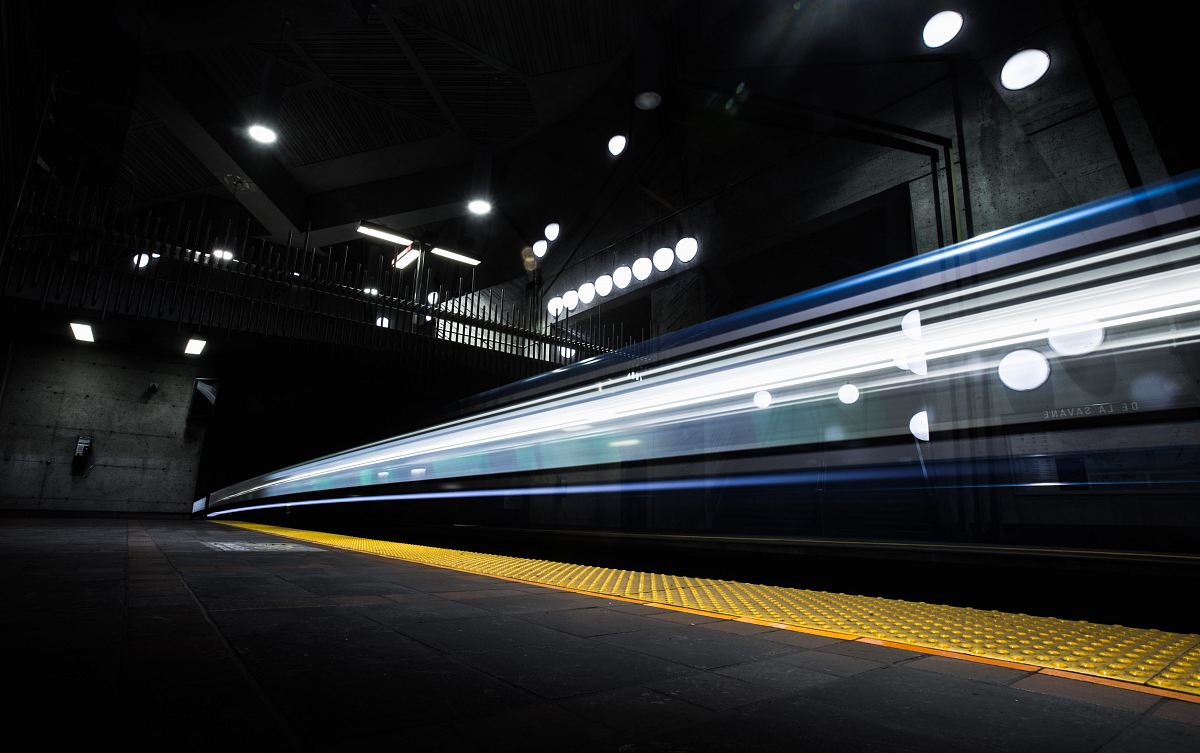 timelapse photography of train passing on track