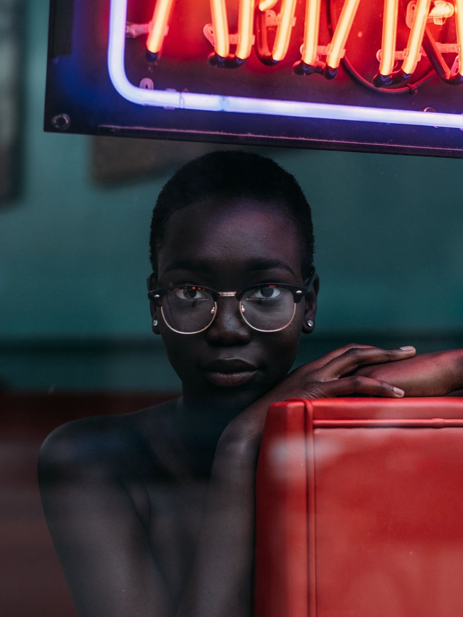 topless woman leaning on chair