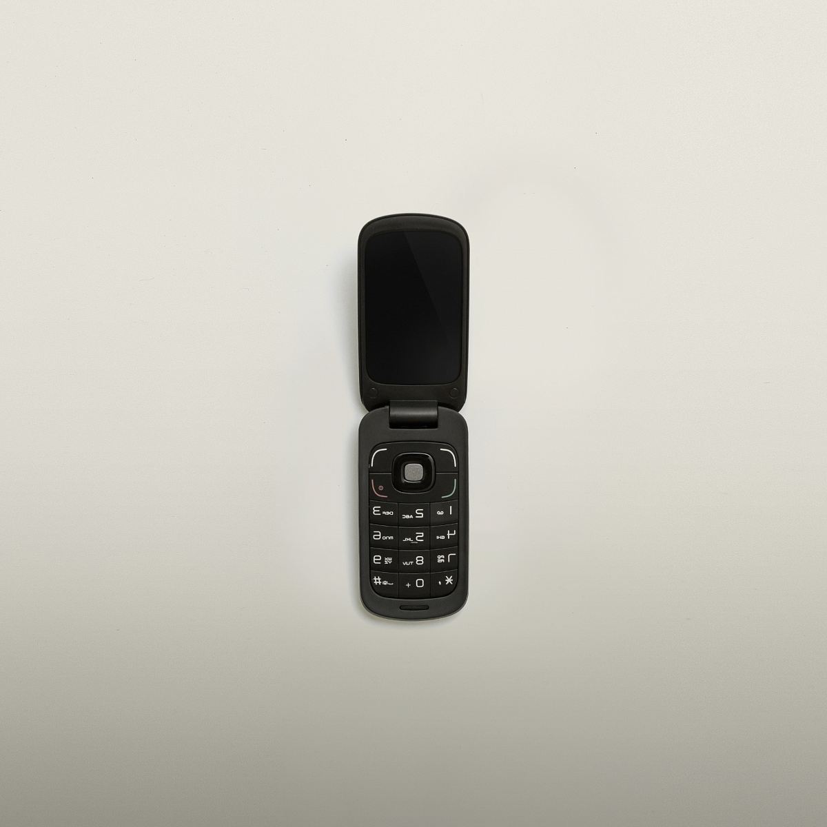 turned-off black flip-phone