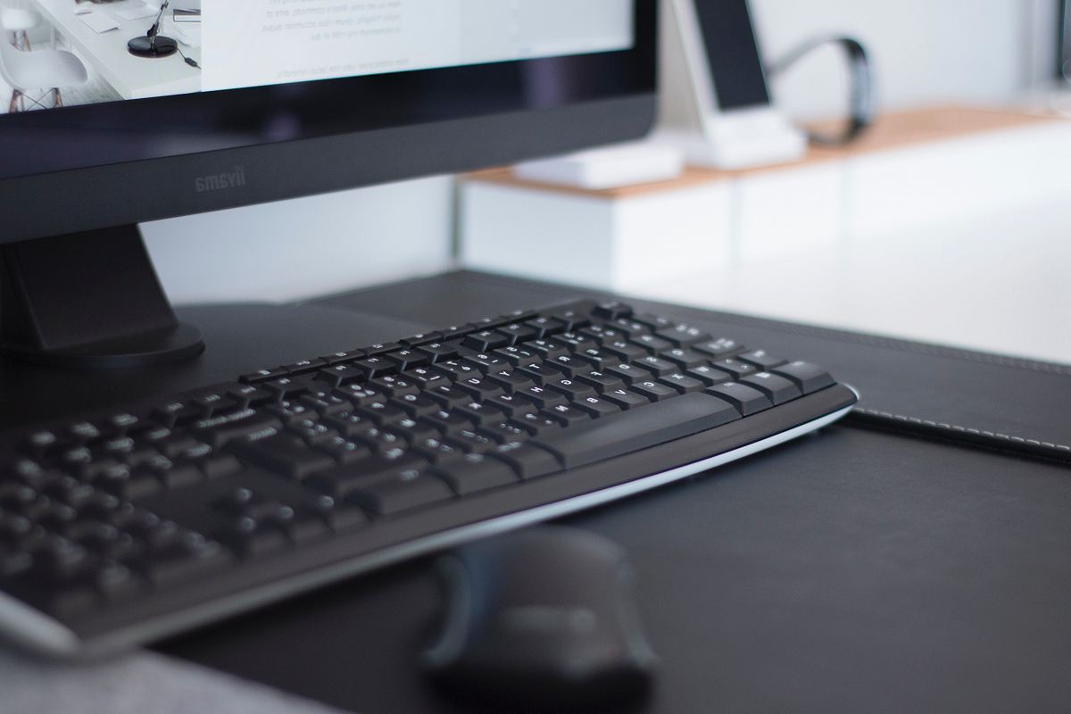 turned-on flat screen monitor and keyboard