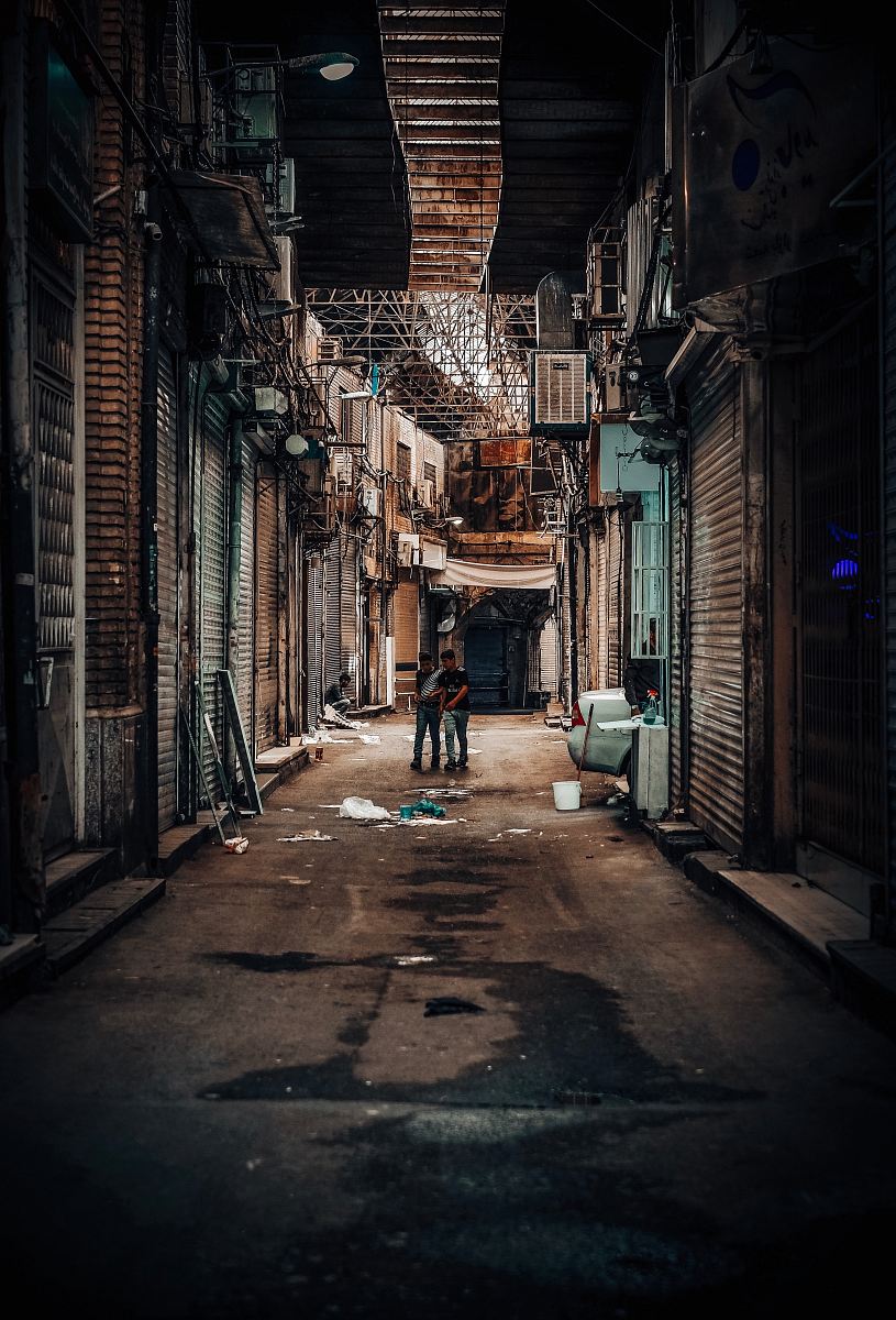 two men walking on street photo