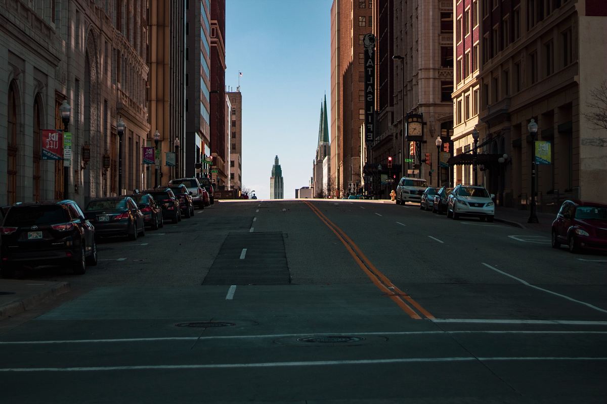 vehicles parked beside high-rise buildings