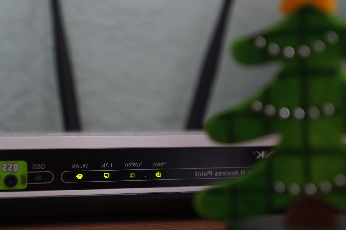 white and black modem router with four lights