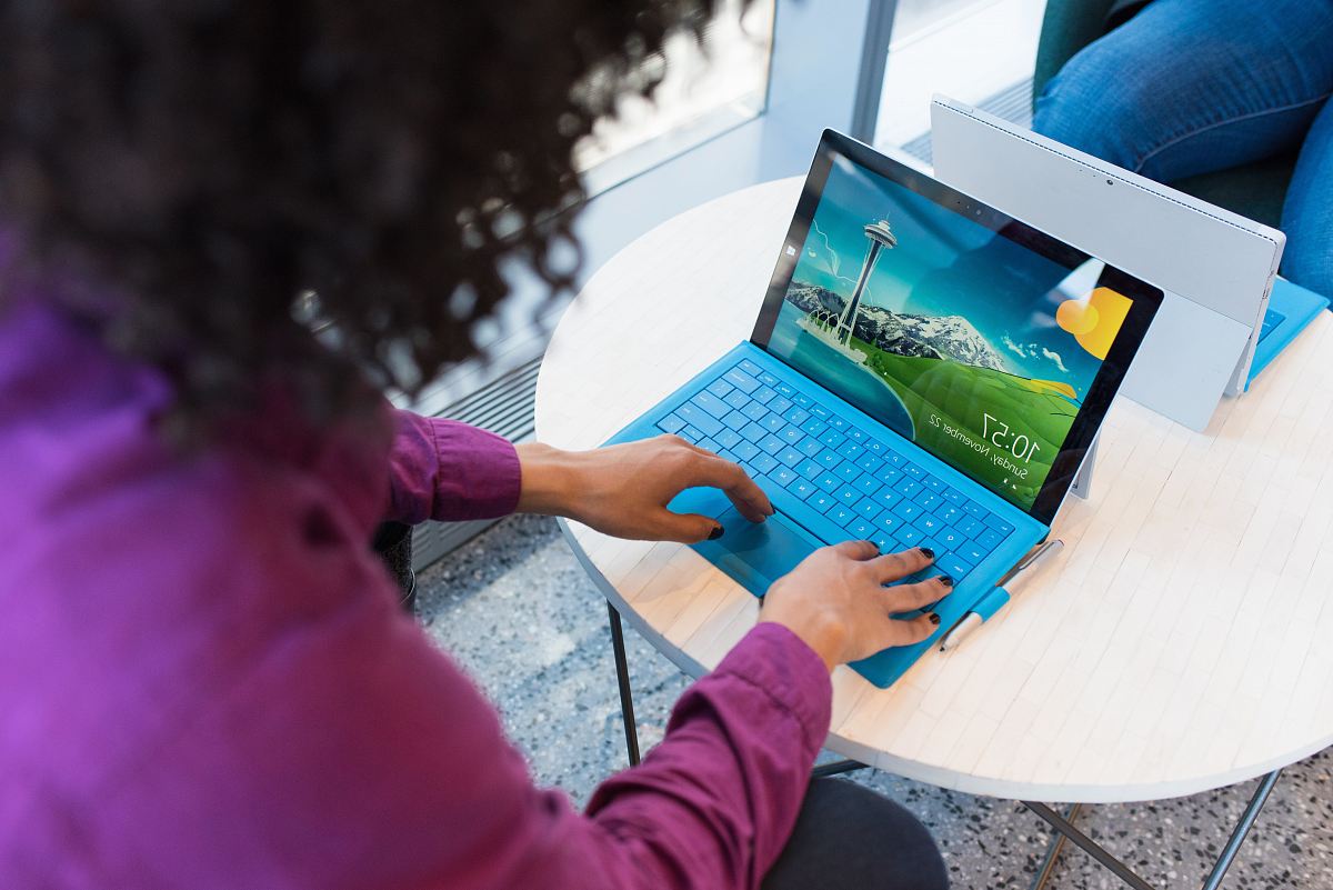 woman in purple sweater using laptop