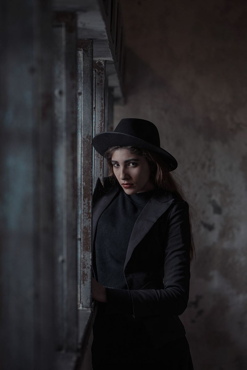woman standing beside steel fence