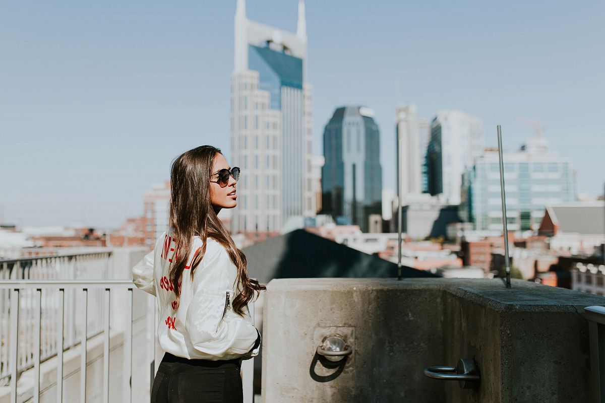 woman standing near hand rails during daytime