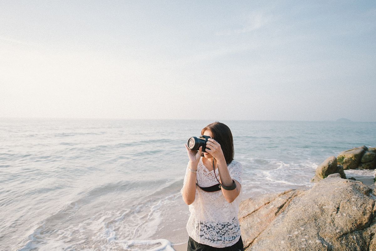 woman taking a photo using a DSLR camera