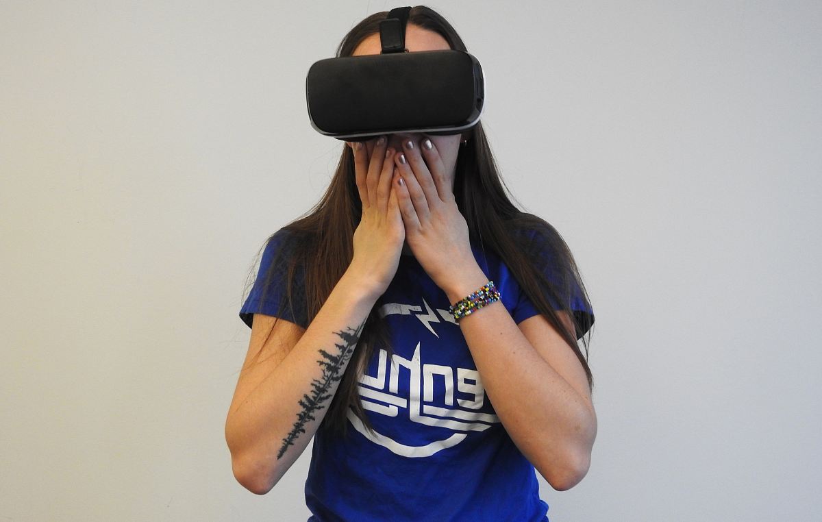 woman using black VR headset