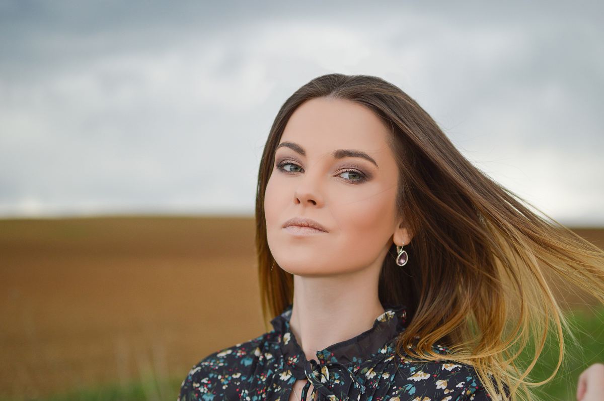 woman wearing floral top at the field during day