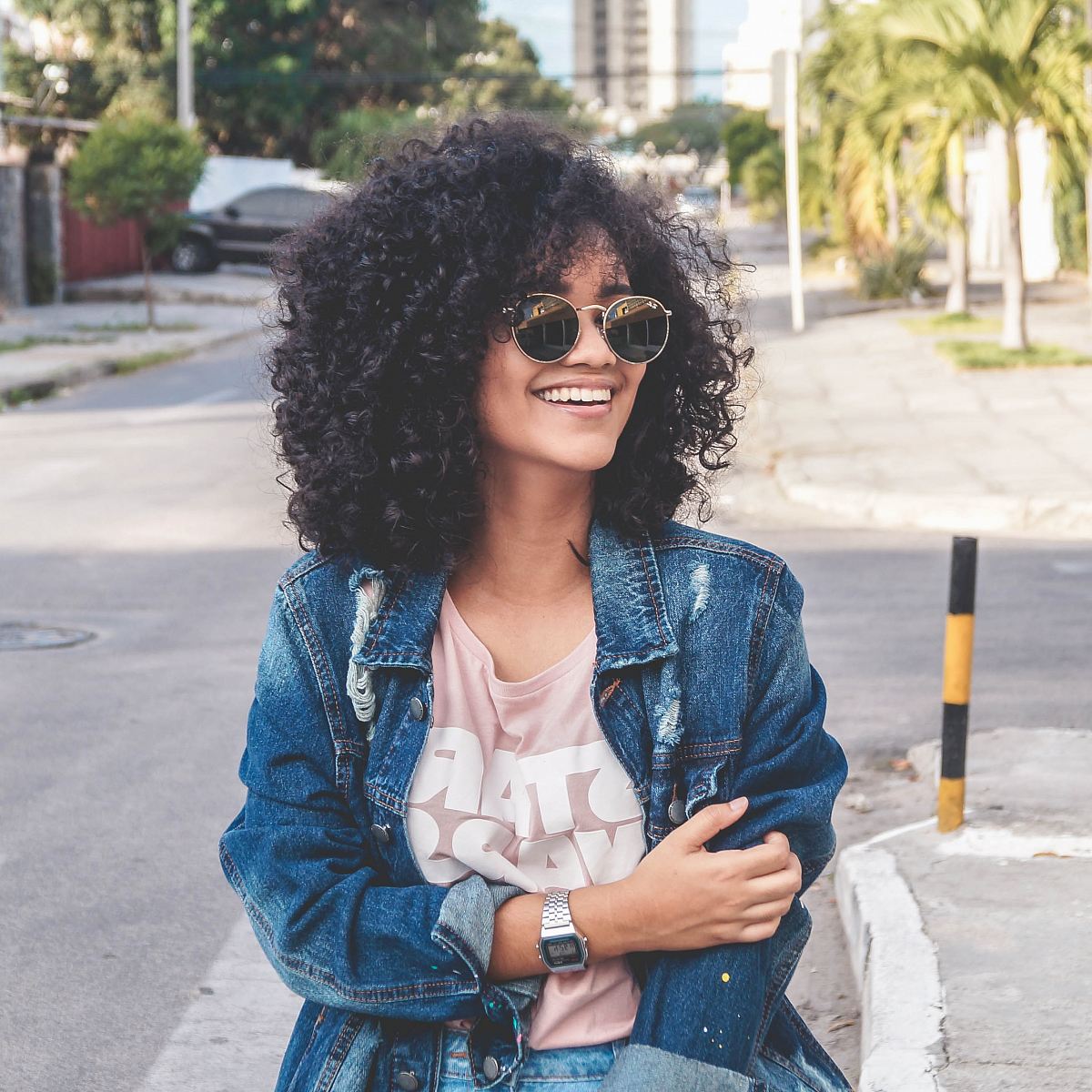 women's wearing blue denim jacket standing on the street