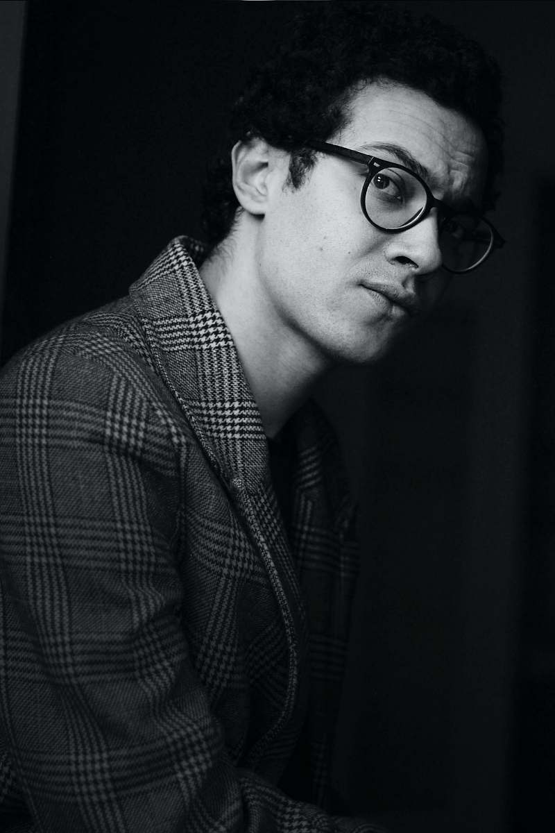  grayscale photo of man wearing suit and eyeglasses 