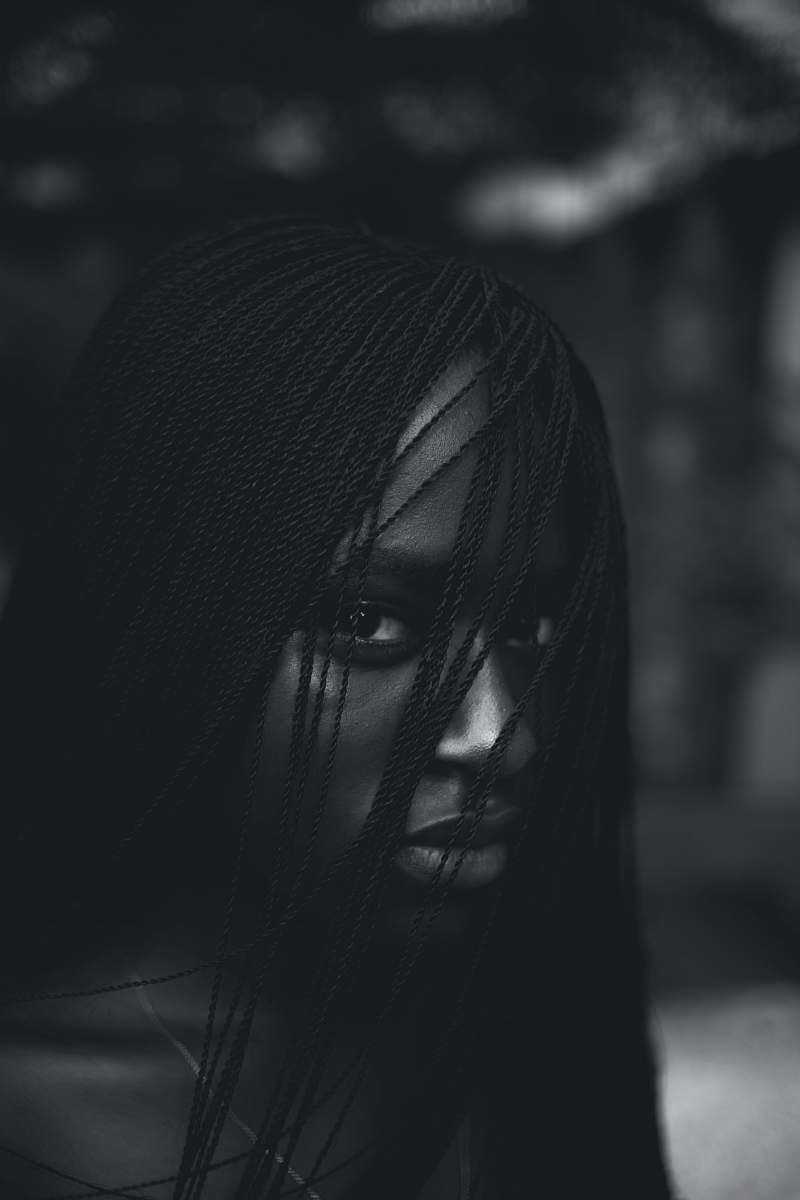  greyscale photo of woman staring at camera 