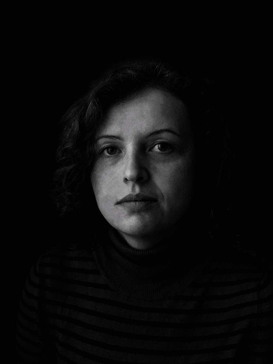 human woman in turtleneck shirt in grayscale photography face