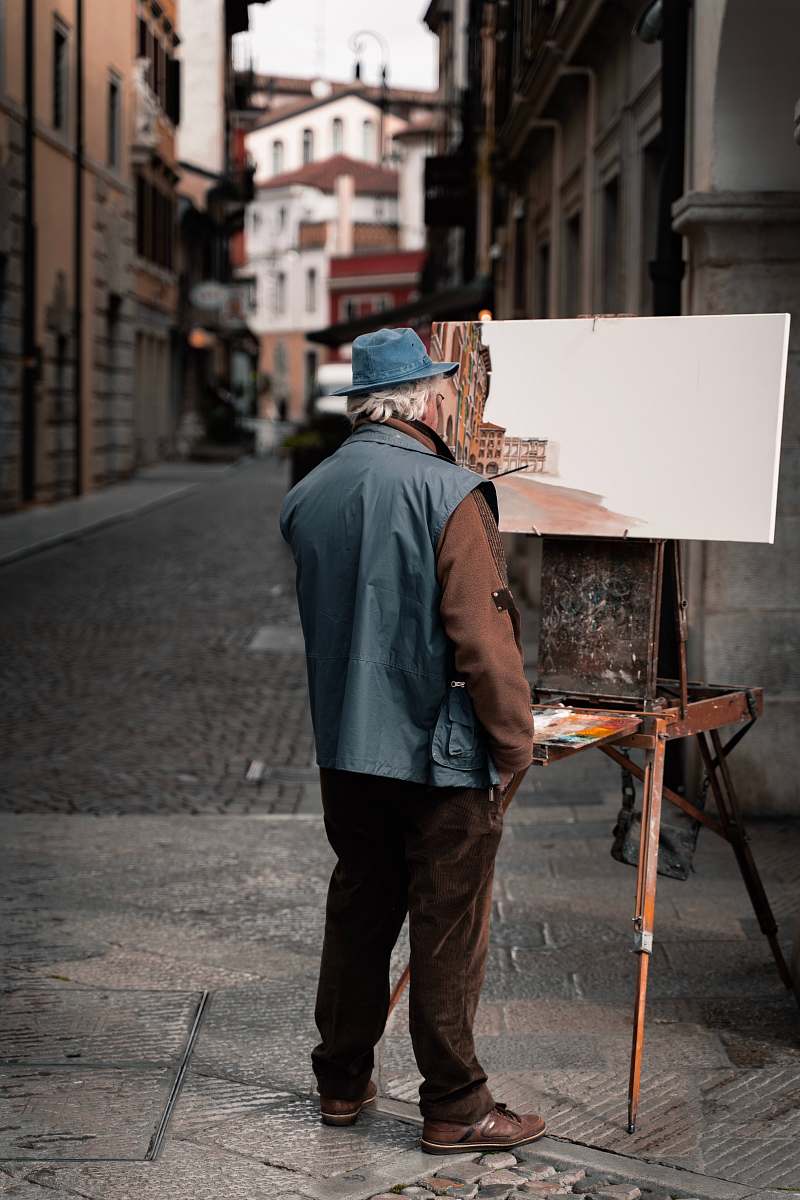 canvas man standing near easel apparel