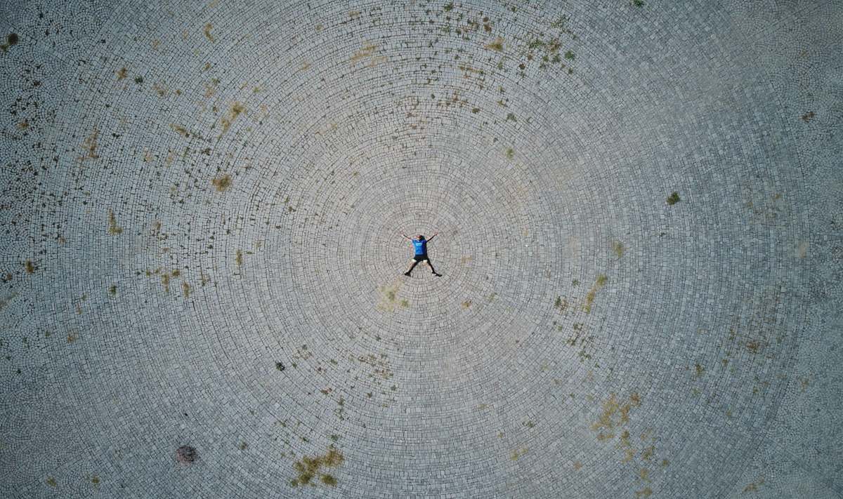 human person lying forward on gray field person