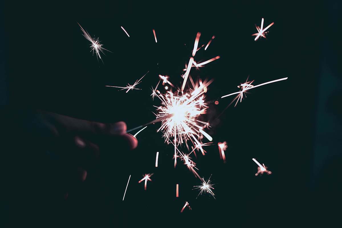 person holding sparkling light 