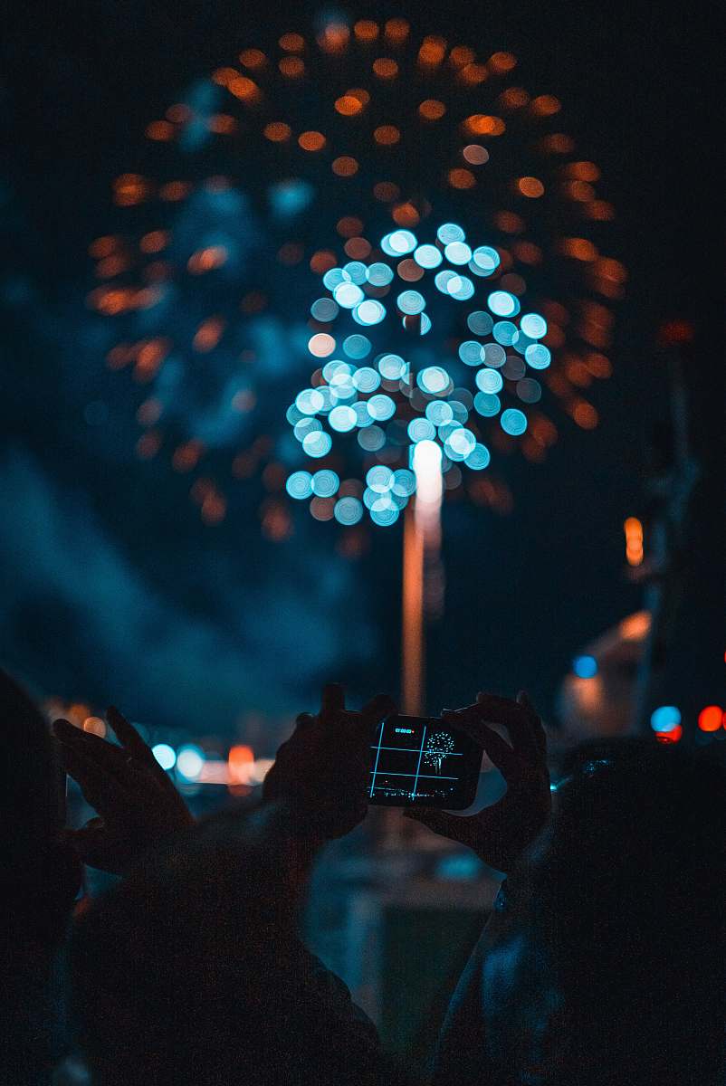  person taking picture of fireworks 
