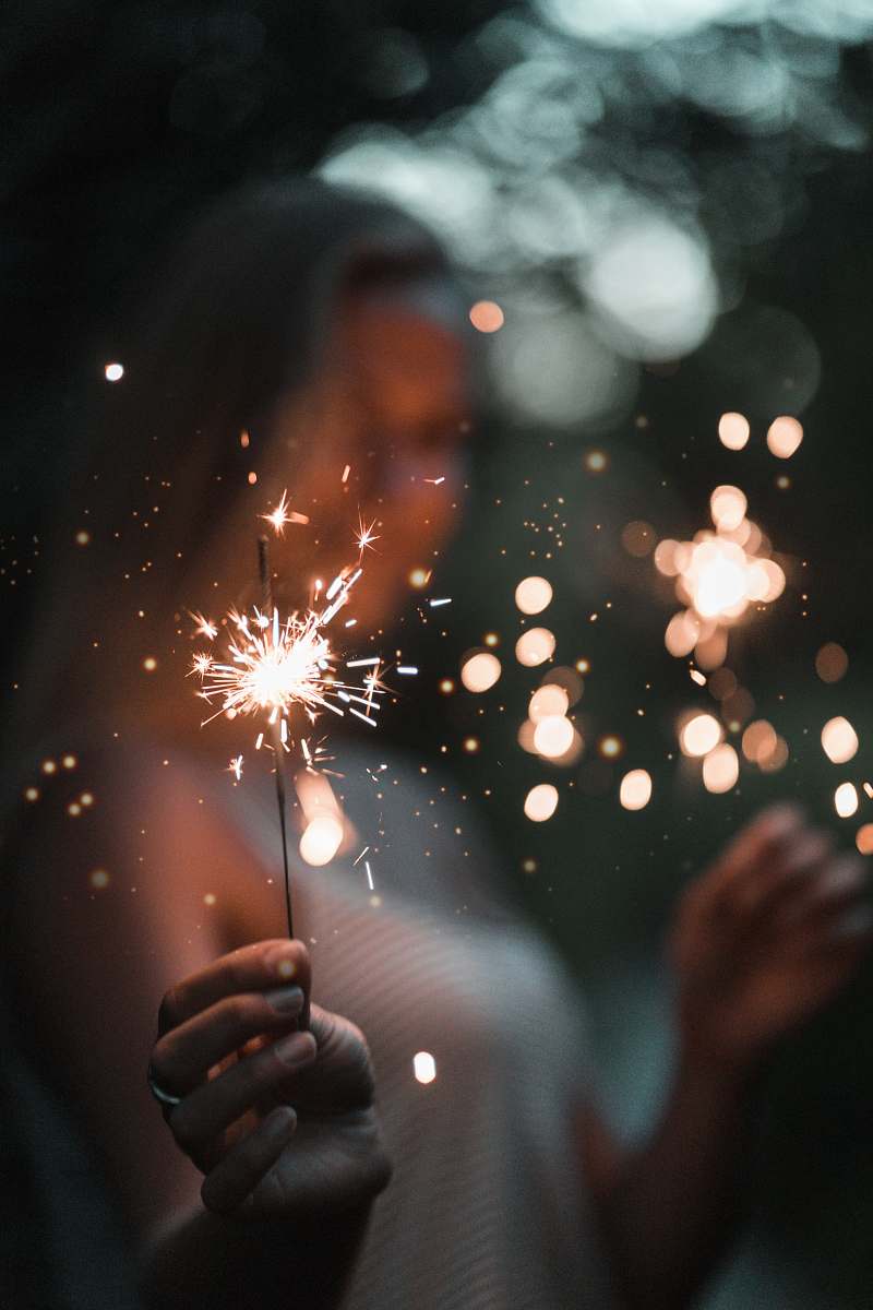  woman holding fire cracker in selective focus photography 