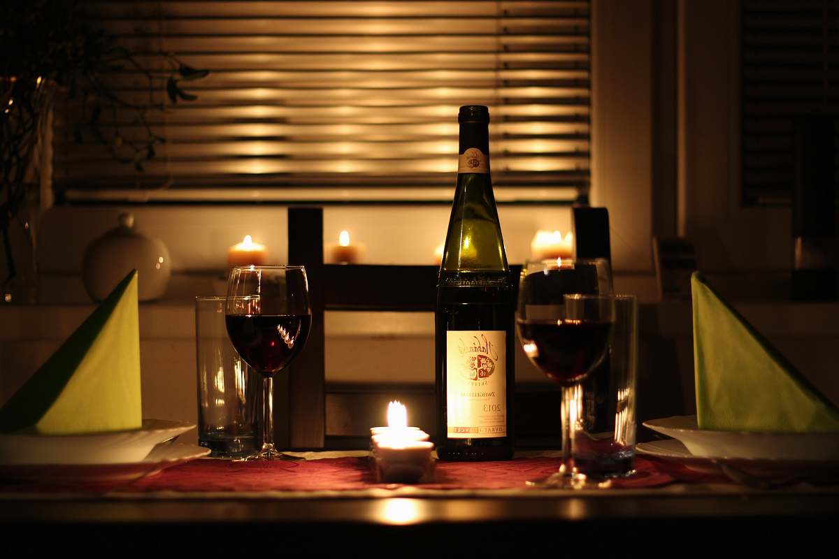bottle wine glass filled with wine beside bottle on table comfort
